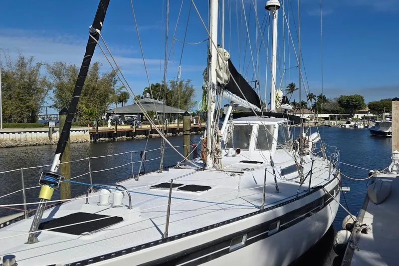 Cookie Monster Too Yacht Photos Pics 1982 Tayana Center Cockpit Cutter Ketch docked in a sunny marina.