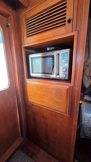 C U Later Yacht Photos Pics Microwave in wooden cabinet on 1987 DeFever 48 Tri Cabin yacht.