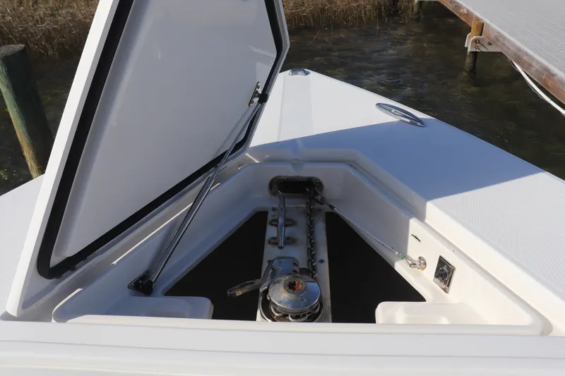  Yacht Photos Pics Open anchor compartment on 2013 Jupiter 30 boat, showcasing storage and mechanism.