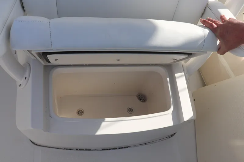 Yacht Photos Pics Open storage compartment on a 2013 Jupiter 30 boat with white cushioned seat.