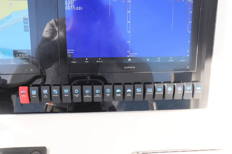  Yacht Photos Pics Control panel of a 2013 Jupiter 30 boat with Garmin display and switches.