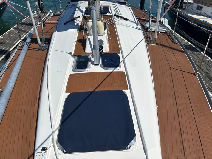 Kells Yacht Photos Pics Deck view of 1996 Nautor Swan 44 Mk II sailboat, featuring teak accents and blue covers.