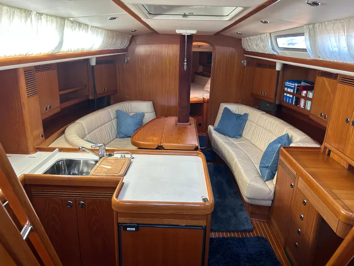 Kells Yacht Photos Pics Luxurious interior of 1996 Nautor Swan 44 Mk II yacht with wood finish and cozy seating.