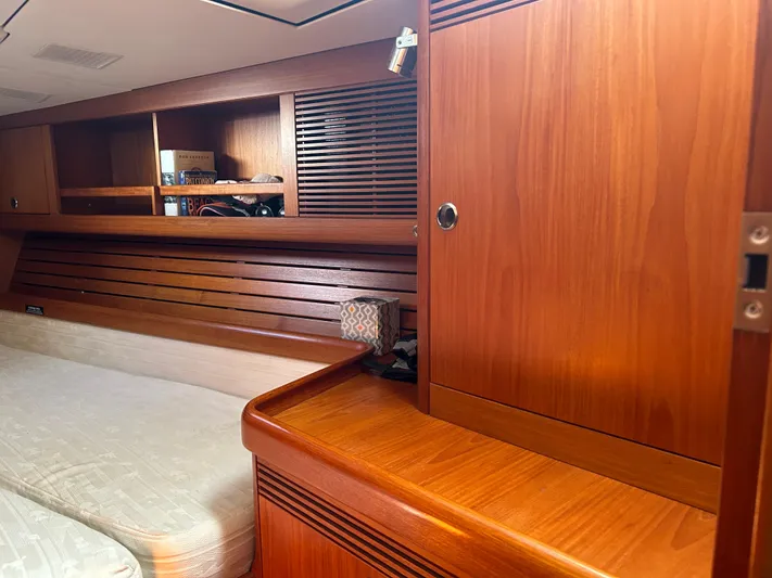 Kells Yacht Photos Pics Interior of 1996 Nautor Swan 44 Mk II yacht with wooden cabinetry and cozy sleeping area.
