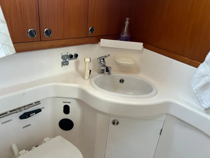 Kells Yacht Photos Pics Bathroom interior of 1996 Nautor Swan 44 Mk II yacht, featuring sink and wooden cabinets.