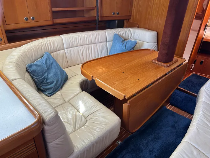 Kells Yacht Photos Pics Luxurious interior of 1996 Nautor Swan 44 Mk II yacht with leather seating and wooden table.