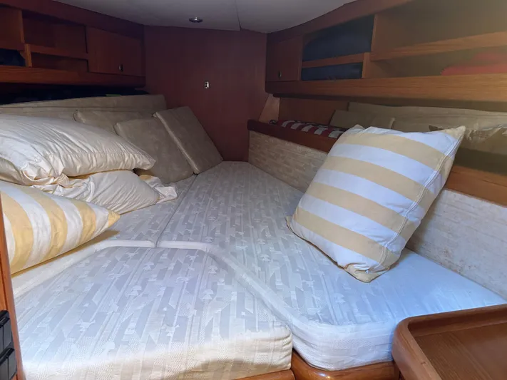 Kells Yacht Photos Pics Cozy cabin interior of 1996 Nautor Swan 44 Mk II with striped pillows and wooden shelves.
