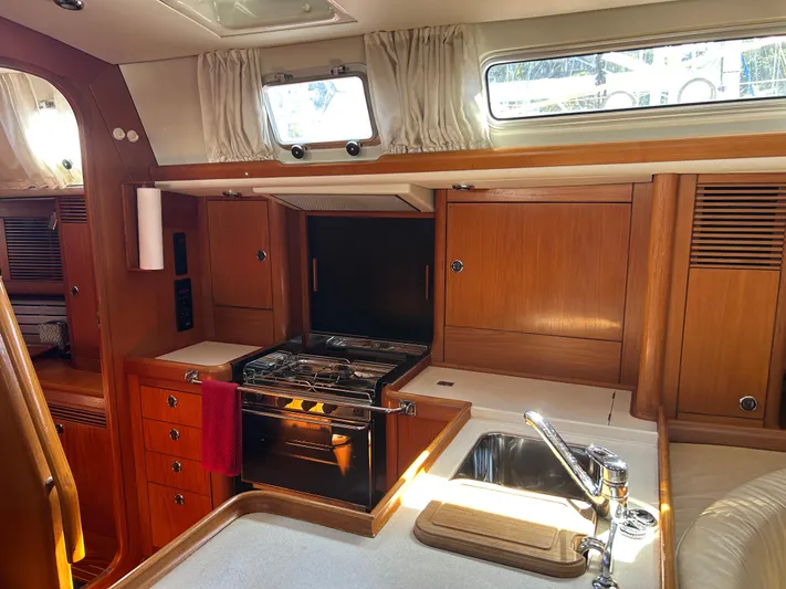 Kells Yacht Photos Pics Interior of 1996 Nautor Swan 44 Mk II yacht, featuring a wooden kitchen with stove and sink.