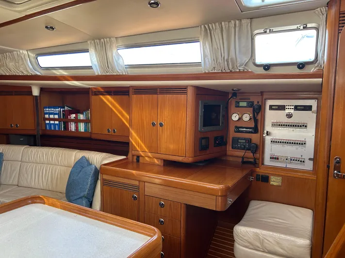 Kells Yacht Photos Pics Interior of 1996 Nautor Swan 44 Mk II yacht with wood cabinetry and navigation equipment.