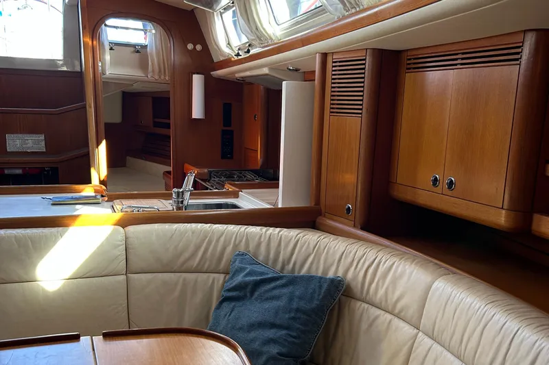 Kells Yacht Photos Pics Interior of 1996 Nautor Swan 44 Mk II yacht with wooden cabinetry and cozy seating.
