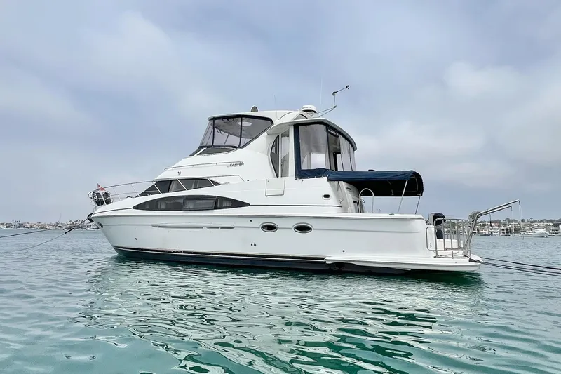  Yacht Photos Pics 2003 Carver 444 Cockpit Motor Yacht on calm water under a cloudy sky.
