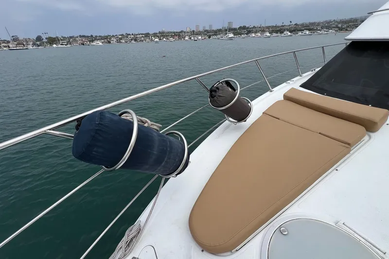  Yacht Photos Pics 2003 Carver 444 Cockpit Motor Yacht with tan sunbed on deck, overlooking marina.