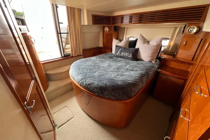  Yacht Photos Pics Luxurious bedroom interior of 2003 Carver 444 Cockpit Motor Yacht with cozy bedding.