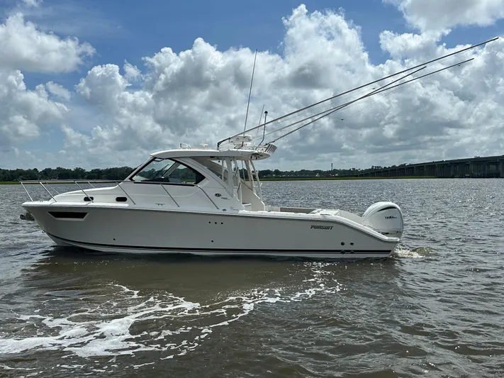  Yacht Photos Pics 2023 Pursuit OS 325 Offshore boat on water under cloudy sky.