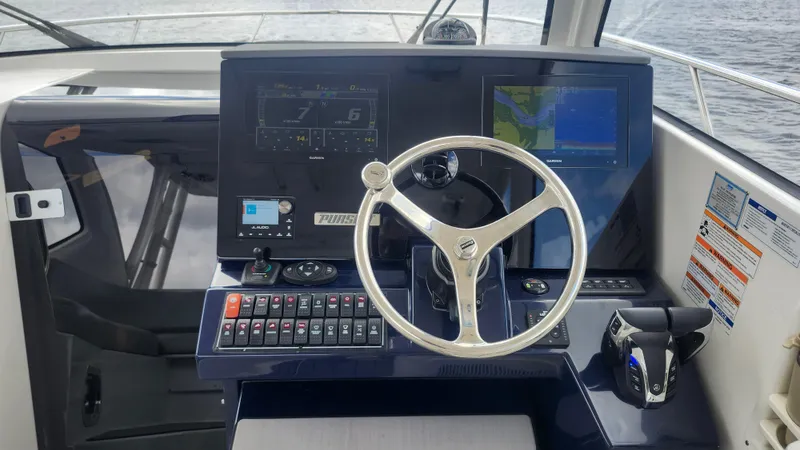  Yacht Photos Pics 2023 Pursuit OS 325 Offshore helm with modern navigation displays and controls.
