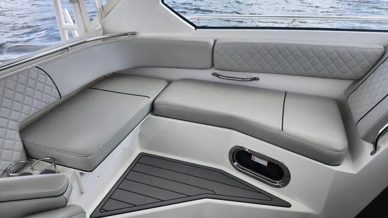  Yacht Photos Pics Luxurious seating on 2023 Pursuit OS 325 Offshore boat, featuring quilted upholstery and sleek design.