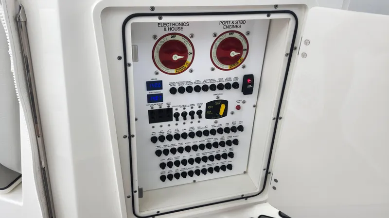  Yacht Photos Pics Electrical control panel on 2023 Pursuit OS 325 Offshore boat, featuring switches and gauges.