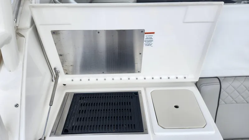  Yacht Photos Pics 2023 Pursuit OS 325 Offshore boat grill and sink area.