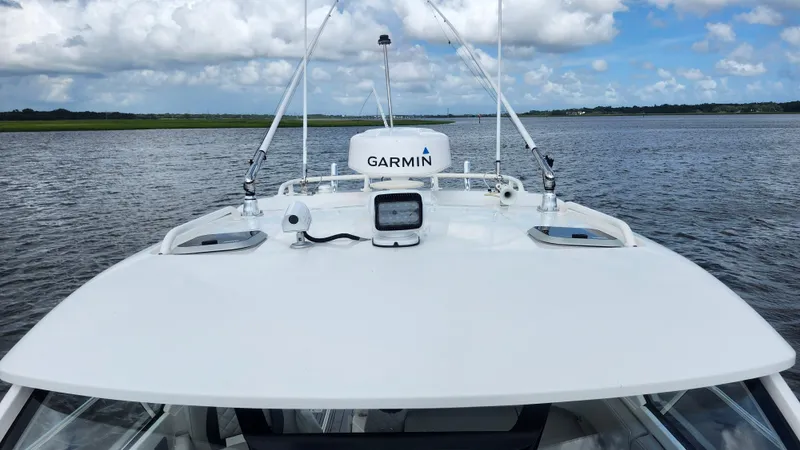  Yacht Photos Pics 2023 Pursuit OS 325 Offshore boat with Garmin equipment on open water.