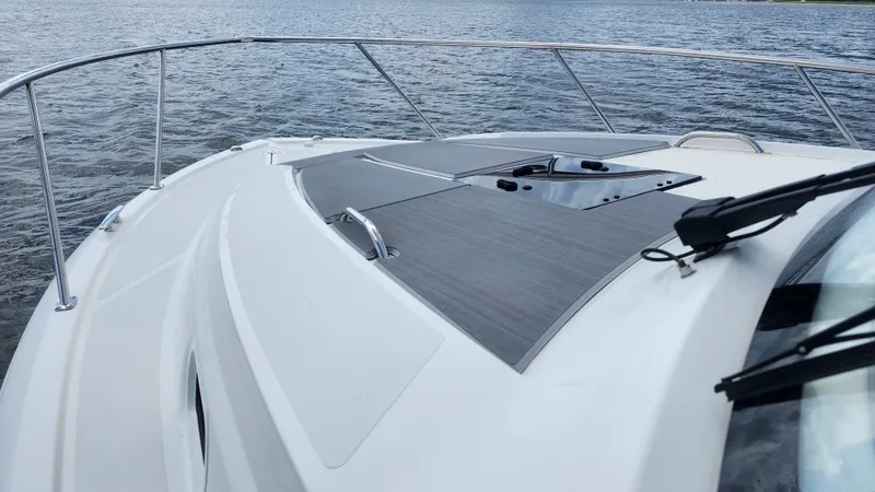  Yacht Photos Pics 2023 Pursuit OS 325 Offshore boat deck on water, showcasing sleek design and modern features.