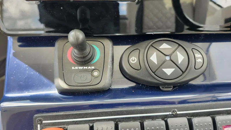  Yacht Photos Pics Control panel of 2023 Pursuit OS 325 Offshore boat with joystick and button interface.