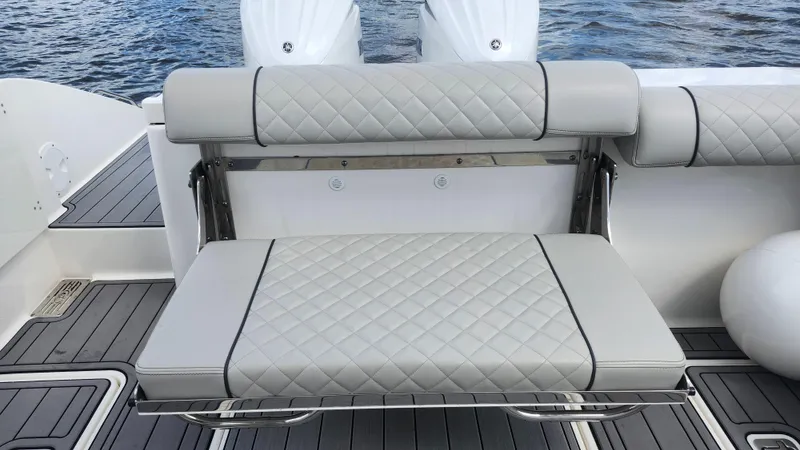  Yacht Photos Pics 2023 Pursuit OS 325 Offshore boat with cushioned seating and sleek design.