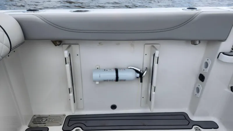  Yacht Photos Pics 2023 Pursuit OS 325 Offshore boat interior with mounted fire extinguisher.