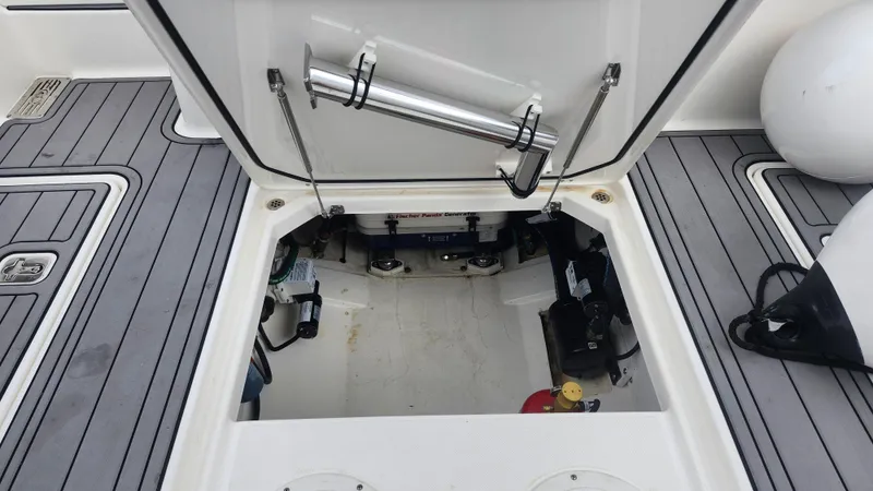  Yacht Photos Pics Open hatch of 2023 Pursuit OS 325 Offshore boat, revealing storage and equipment.