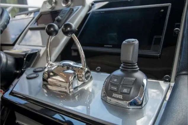 Why Knot Yacht Photos Pics Control panel of a 2011 Marquis Sport Coupe with joystick and throttle levers.