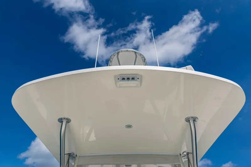  Yacht Photos Pics 2018 SeaVee 370Z boat against a bright blue sky with clouds.