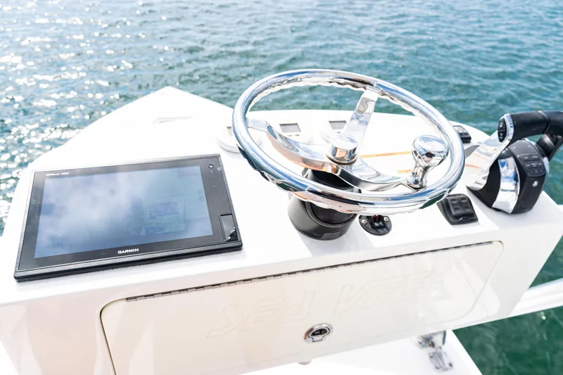  Yacht Photos Pics 2018 SeaVee 370Z helm with Garmin display and chrome steering wheel on open water.