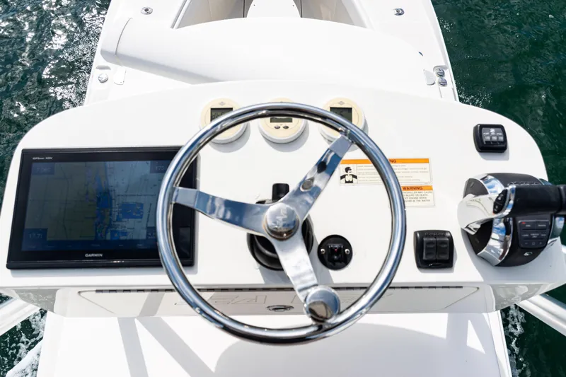  Yacht Photos Pics 2018 SeaVee 370Z boat helm with steering wheel, GPS display, and controls on open water.