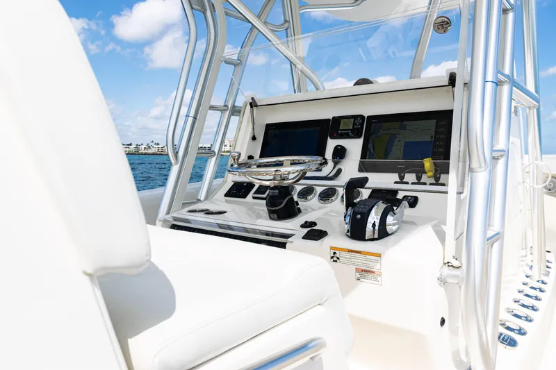  Yacht Photos Pics 2018 SeaVee 370Z boat helm with modern navigation equipment and controls, set against a clear blue sky.
