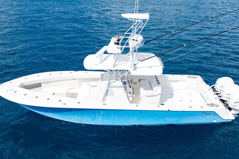  Yacht Photos Pics 2018 SeaVee 370Z boat on clear blue ocean water, featuring a sleek design and fishing equipment.