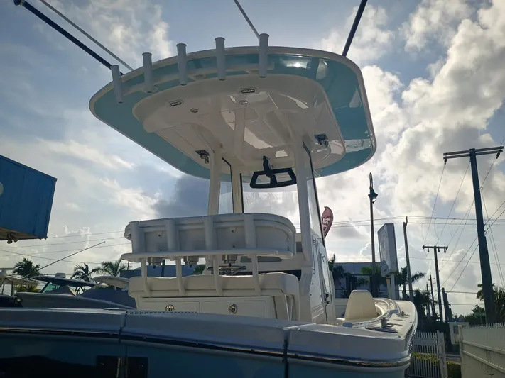 23-374 Yacht Photos Pics 2025 Regulator 23 boat with T-top against a cloudy sky background.