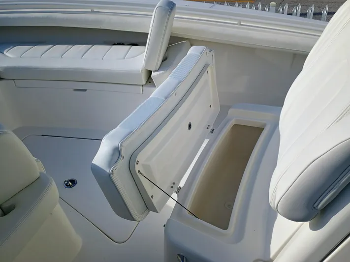 23-374 Yacht Photos Pics 2025 Regulator 23 boat interior with open storage compartment and white seating.