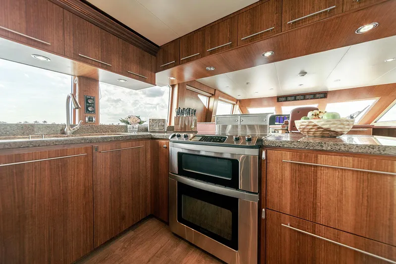 Dark Horse Yacht Photos Pics Luxurious kitchen interior of 2007 Hargrave 78 Open Bridge yacht with modern appliances.