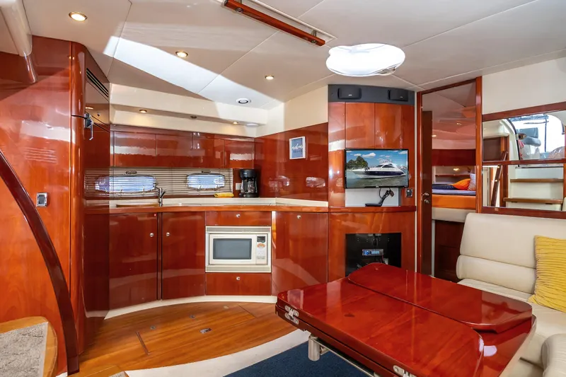 Ami Kids Donation: Meditrina Yacht Photos Pics Luxurious 2006 Fairline Targa 47 GT yacht interior with modern kitchen and cozy seating area.