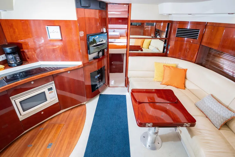 Ami Kids Donation: Meditrina Yacht Photos Pics Luxurious interior of 2006 Fairline Targa 47 GT yacht with modern kitchen and cozy seating.