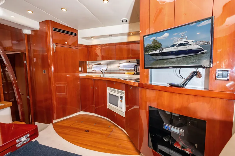 Ami Kids Donation: Meditrina Yacht Photos Pics Luxurious interior of 2006 Fairline Targa 47 GT yacht with wood finishes and modern amenities.