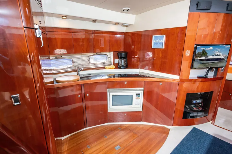 Ami Kids Donation: Meditrina Yacht Photos Pics Luxurious 2006 Fairline Targa 47 GT yacht interior with modern kitchen and entertainment area.