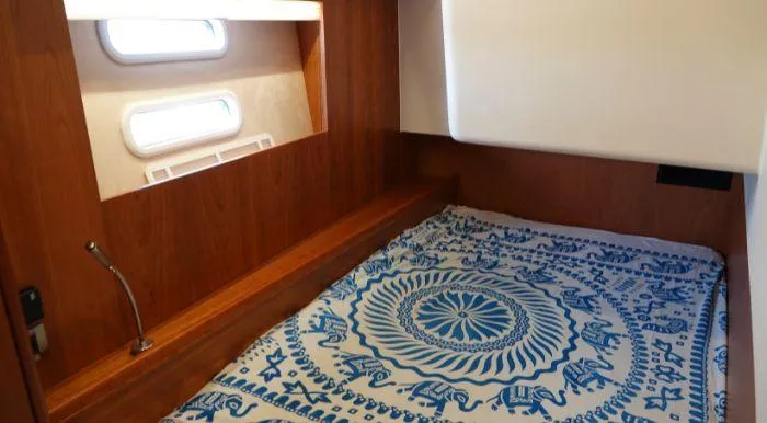 Heolia Yacht Photos Pics Cozy cabin interior of 2018 Hanse Moody 54 DS yacht with patterned bedding.