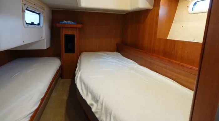 Heolia Yacht Photos Pics Cabin interior of 2018 Hanse Moody 54 DS yacht with twin beds and wooden finish.