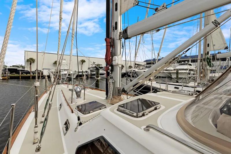 Clarity Yacht Photos Pics 2009 Hylas 54 sailboat docked at marina, showcasing deck and rigging under blue sky.