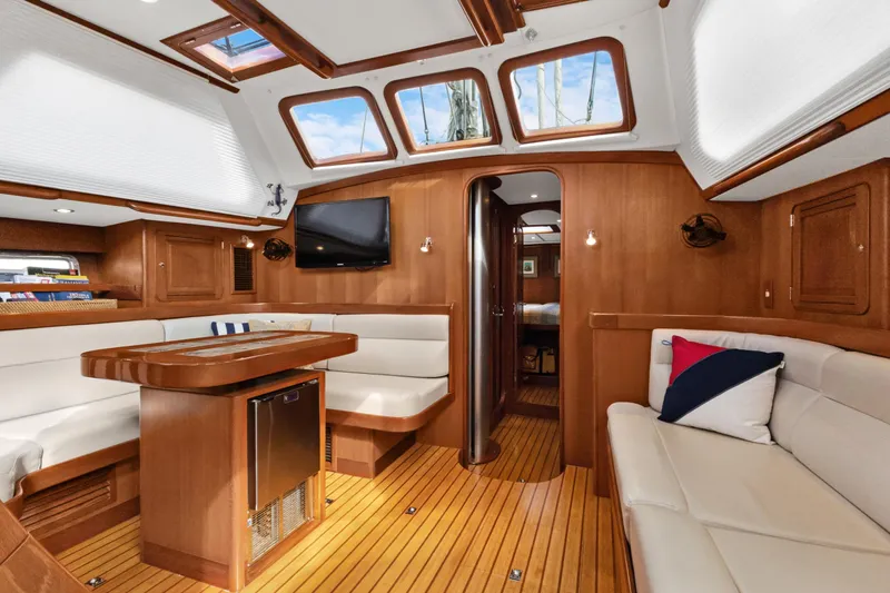 Clarity Yacht Photos Pics Luxurious interior of a 2009 Hylas 54 yacht with wood finishes and comfortable seating.