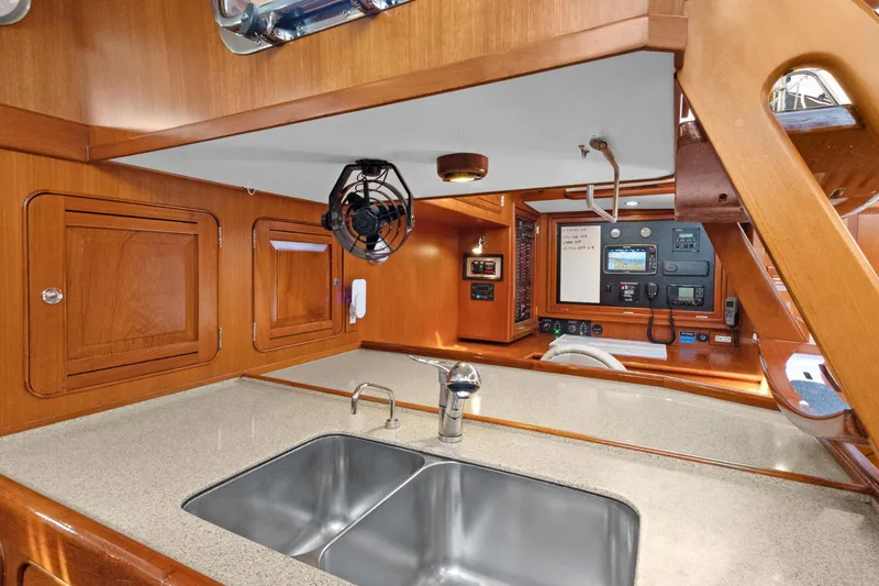 Clarity Yacht Photos Pics Luxurious 2009 Hylas 54 yacht interior with modern kitchen and navigation controls.