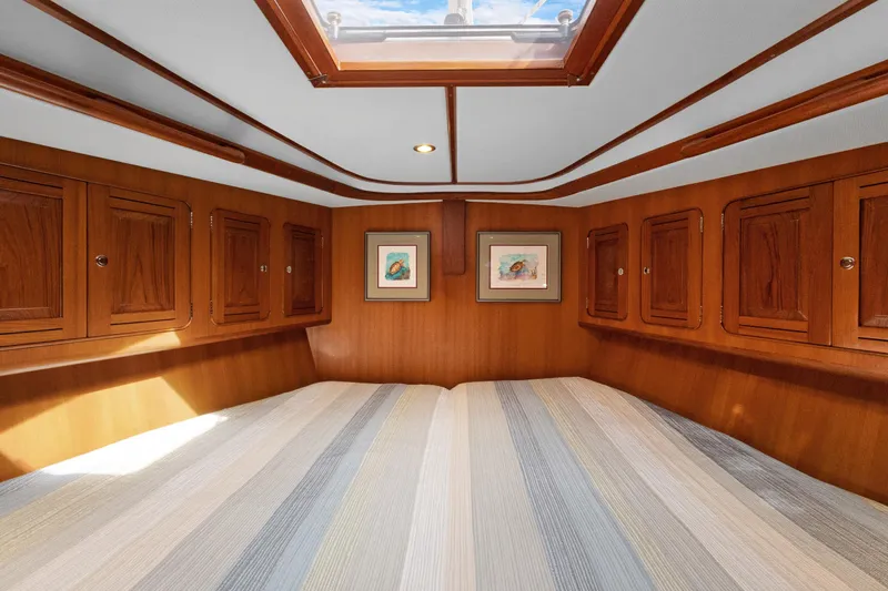 Clarity Yacht Photos Pics Luxurious 2009 Hylas 54 yacht cabin with wood paneling and skylight.