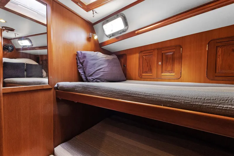 Clarity Yacht Photos Pics Cozy cabin interior of 2009 Hylas 54 yacht with wooden finish and bunk beds.