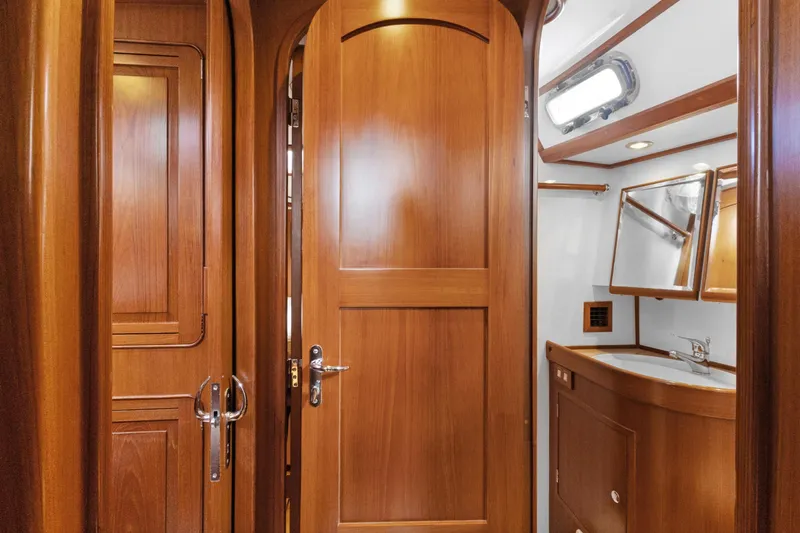 Clarity Yacht Photos Pics Luxurious wooden interior of 2009 Hylas 54 yacht bathroom with sink and mirror.