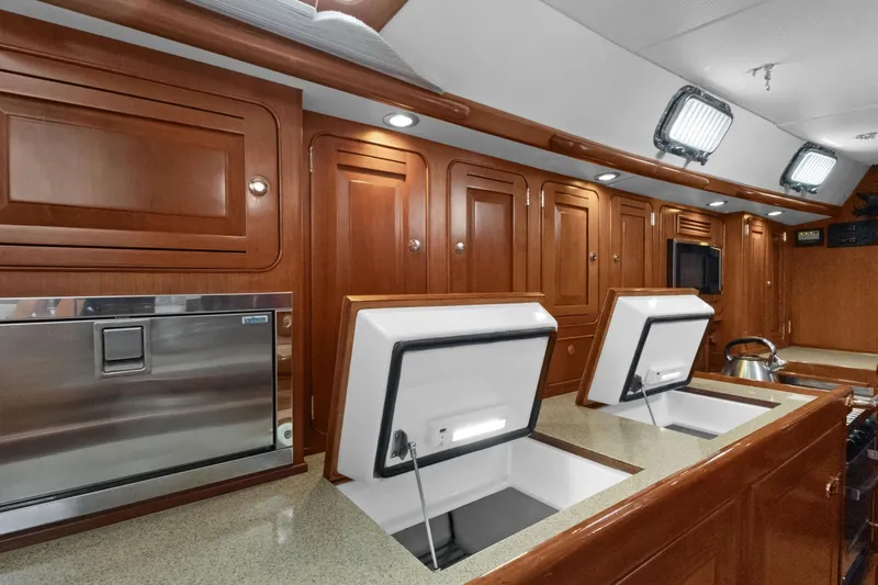 Clarity Yacht Photos Pics Luxurious 2009 Hylas 54 yacht interior with wooden cabinetry and modern kitchen amenities.